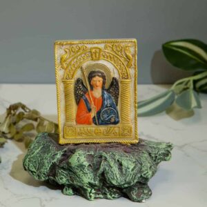 Decorative figurine of St. Michael the Archangel on a rock