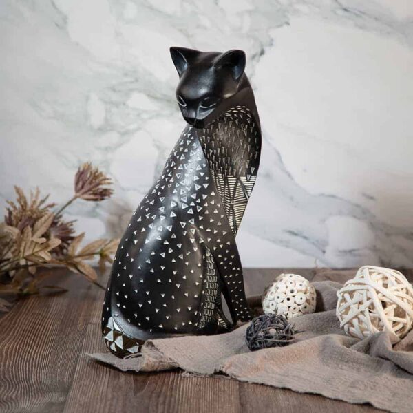 Cat statuette with round white dots